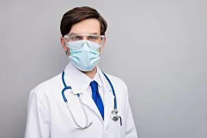 White Work Prints: Photo of attractive handsome serious doc guy professional experienced skilled surgeon wear facial protective mask
