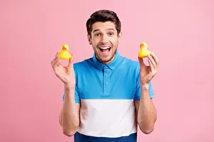 Careless Prints: Photo of cool brunet millennial guy hold toy wear blue t-shirt isolated on pink color background