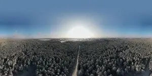 photo from a flying drone, a small planet and a winter landscape, pines and spruces are covered with snow