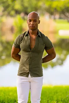 Well Being Prints: Photo of a handsome Black male model posing ith arms behind his back