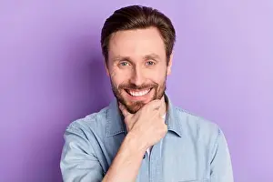 Chin Prints: Photo of happy smiling man showing perfect teeth after stomatology treatment isolated on purple color background