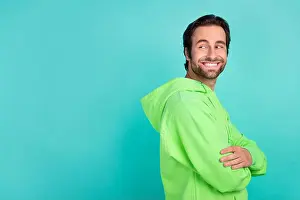 Crossed Prints: Photo of masculine guy crossed arms look empty space shopping concept wear green hoodie isolated teal color background