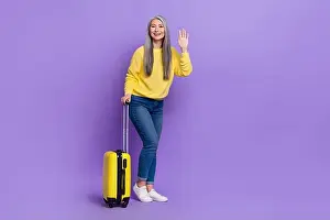 Check In Prints: Photo of pretty friendly lady pensioner dressed pullover carrying luggage waving arm isolated purple color background