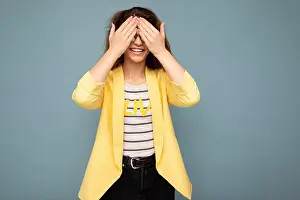 Empty Space Prints: Photo shot of young positive happy nice cute brunette curly woman with sincere emotions wearing trendy yellow jacket