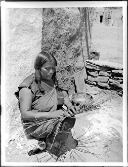 Indian Woman Prints: A photograph from around 1900 showing a Hopi Indian woman engaged in basket making