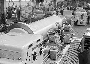 Craft Prints: This photograph depicts a worker operating a heavy lathe in Maribor