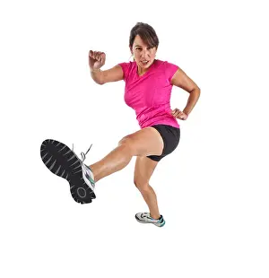 Conscious Prints: Photograph of young female kickboxer in a fighting stance with sole of her shoe extended toward the camera