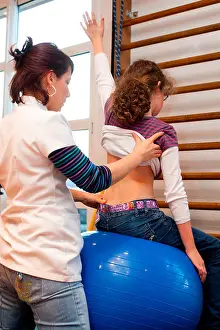 Functional Prints: Physical Therapist practicing stretching and flexibility of a 12 year old girl suffering from scoliosis