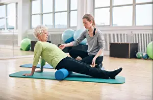 Problems Prints: Physical therapist working with active senior woman at rehab