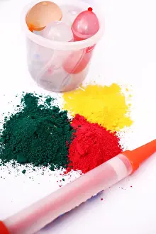 Balloons Prints: Picture of holi color and pichkari with water balloons in bucket for holi fun