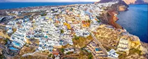 Santorini Prints: Picturesque Aerial drone view of famous Oia village with white houses during sunrise on Santorini island