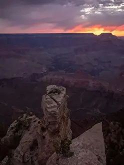 Uneven Prints: Picturesque aerial view of rough rocky formations against cloudy sundown sky in evening in USA