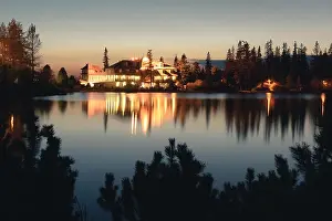 Picturesque autumn view of lake Strbske pleso in High Tatras National Park, Slovakia. Clear water with reflections of illuminated hotels on background