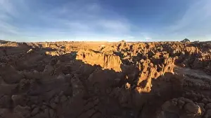 Uneven Prints: Picturesque drone view of unusual mushroom shaped rock pinnacles under cloudless blue sky in Goblin Valley State Park