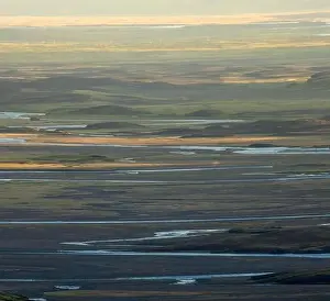 Valley River Prints: Picturesque drone view of valley with river and hills illuminated with sunlight early in morning in Iceland