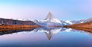 Picturesque landscape with colorful sunrise on Stellisee lake. Snowy Matterhorn Cervino peak with reflection in clear water. Zermatt, Swiss Alps
