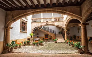 Palma Prints: Picturesque mediterranean courtyard with stone pillars and flowers