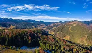 Picturesque mountain landscapes of autumn with snow near the village of Dzembronya in Ukraine Carpathians mountains