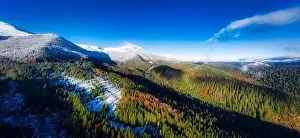 Picturesque mountain landscapes of autumn with snow near the village of Dzembronya in Ukraine Carpathians mountains