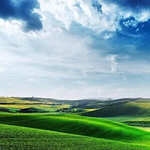 Images Dated 22nd April 2019: Picturesque rural landscape with green agricultural fields, spring hills and blue sky