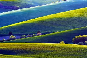 Picturesque rural landscape with green agricultural fields and trees on spring hills. South Moravia region, Czech Republic