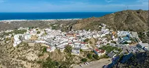 Picturesque spanish hillside white washed village of Mojacar during sunny day against blue sky