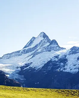 Picturesque view on Bachalpsee lake in Swiss Alps mountains. Snowy peaks of Wetterhorn, Mittelhorn and Rosenhorn on background