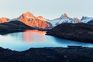 Picturesque view on Bachalpsee lake in Swiss Alps mountains. Snowy peaks of Wetterhorn, Mittelhorn and Rosenhorn on background