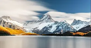 Picturesque view on Bachalpsee lake in Swiss Alps mountains. Snowy peaks of Wetterhorn, Mittelhorn and Rosenhorn on background
