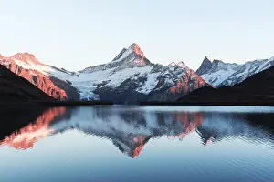 Picturesque view on Bachalpsee lake in Swiss Alps mountains. Snowy peaks of Wetterhorn, Mittelhorn and Rosenhorn. Grindelwald valley, Switzerland