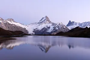 Picturesque view on Bachalpsee lake in Swiss Alps mountains. Snowy peaks of Wetterhorn, Mittelhorn and Rosenhorn on background. Switzerland