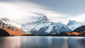 Picturesque view on Bachalpsee lake in Swiss Alps mountains. Snowy peaks of Wetterhorn, Mittelhorn and Rosenhorn on background. Switzerland