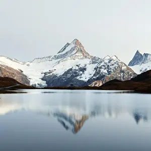 Picturesque view on Bachalpsee lake in Swiss Alps mountains. Snowy peaks of Wetterhorn, Mittelhorn and Rosenhorn on background. Grindelwald valley