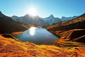 Picturesque view on Bachalpsee lake in Swiss Alps mountains. Snowy peaks of Wetterhorn, Mittelhorn and Rosenhorn on background