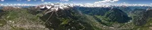 Uneven Prints: Picturesque view of mountain range with sharp peaks covered with snow and green grass on sunny spring day in the Alps