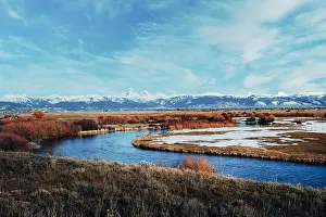 Wide Open Prints: Picturesque view of snow covered Teton mountain range with a winding river in the foreground