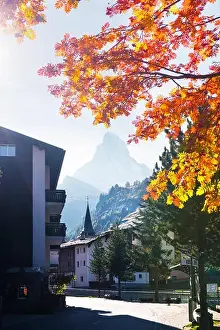 Picturesque view of Zermatt city street with Matterhorn peak and yellow ash tree in Swiss Alps. Switzerland, Europe. Landscape photography