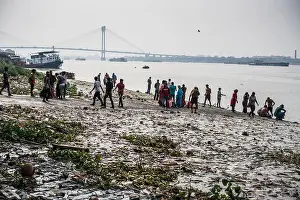 West Bengal Prints: Pilgrims have bath in Ganga river, Kolkata, India, Asia