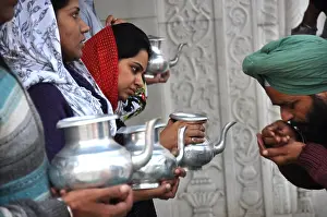Reflecting Prints: Pilgrims drinking holy water, Bangla Sahib Gurudwara