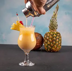 Milkshake Prints: Pina Colada over wooden background garnished pineapple