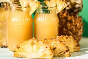 Pineapple Prints: Pineapple juice and slice placed on a wooden table