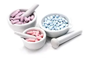Tablets Prints: Pink, blue and purple tablets in three mortar and pestles on white background