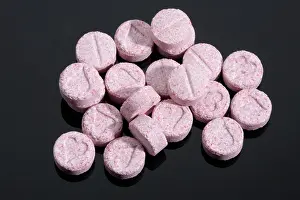 Dealer Prints: Pink coloured Ecstasy tablet illegal drugs Pills