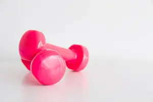 Bodybuilding Prints: Two pink glossy dumbbell isolated on white