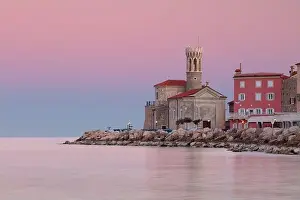 Piran, Slovenia. Cityscape image of Piran, Slovenia with historical church and lighthouse at sunrise