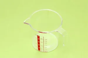 Household Prints: Plastic kitchen measuring cup on table background