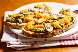 Avocado Prints: Plate with avocado toasts with mushrooms and vegan cheddar (carrots)
