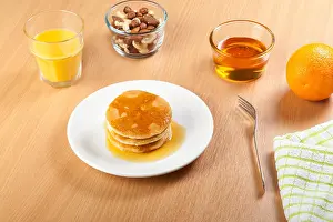 Cakes Prints: Plate of syrup covered pancakes with a bowl of mixed nuts