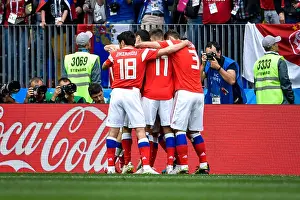 Players of Russia celebrate after Yuri Gazinsky scord the first goal against Saudi Arabia in their Group A match during