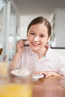 Messing Prints: Playful girl smearing cake on her nose
